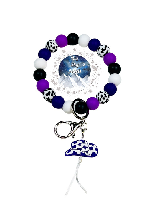 Purple Cowboy Hat Wristlet Keychain Silicone White W/ Black Cow Print Silicone Cow Print Beads, Black, Purple, Deep Purple and White. Ages 8+ Kids or Ladies, Me, Moms Western West